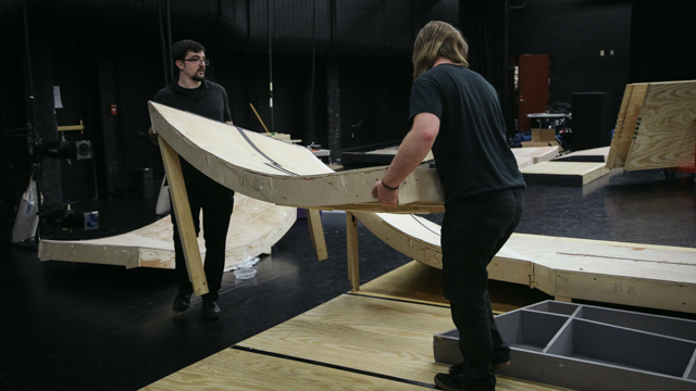 The production crew re-assembles the ramp.