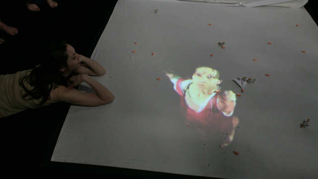 Performer Savina Theodorou looks at Kate Freer's projection installation.
