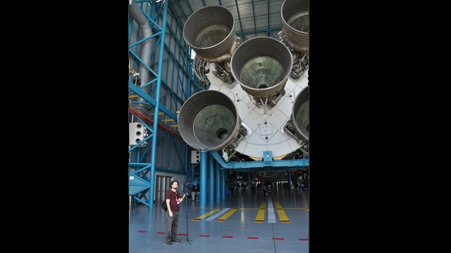 Collaborator Kevin Obsatz beside a rocket at Kennedy Space Center